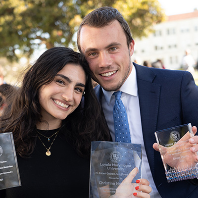 two students holding their awards