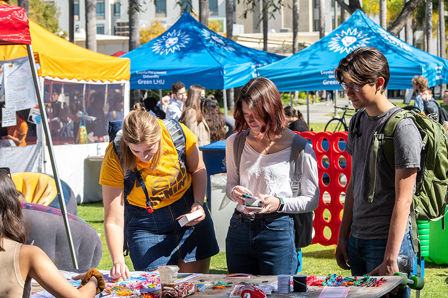 three students at a Wellness Wednesday booth