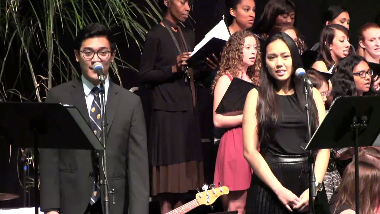 Choir singing into a microphone during mass