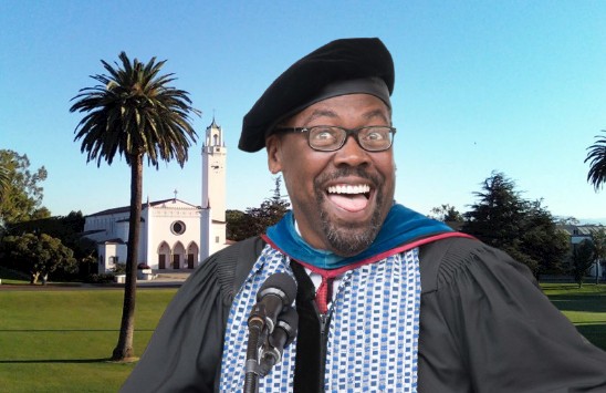 Dean Bryant Alexander wearing cap and gown in front of a Zoom background of Sacred Heart Chapel