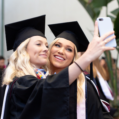 Two female gradutes taking a selfie