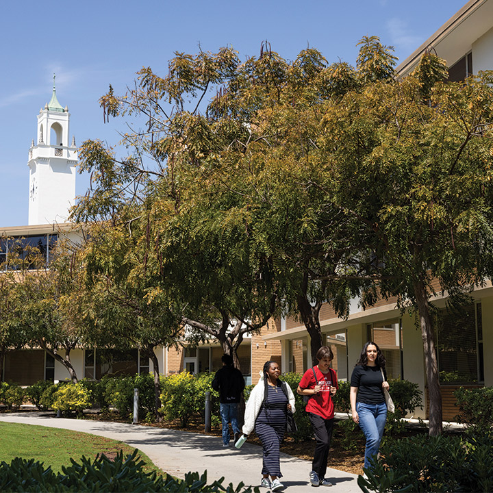 Three students walking on LMU's Westchester Campus